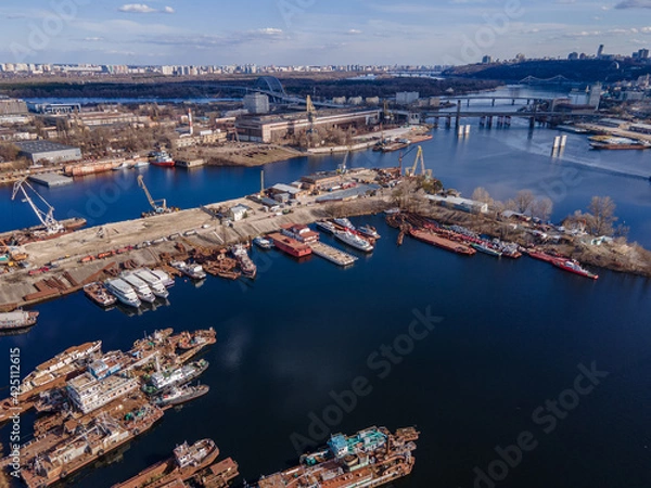 Fototapeta Aerial view of moored old barges and ships in river port