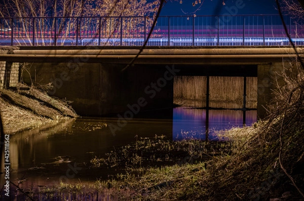 Obraz Bridge over the river at night.