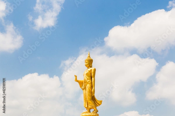 Fototapeta The standing buddha with blue sky and cloud,Copy space