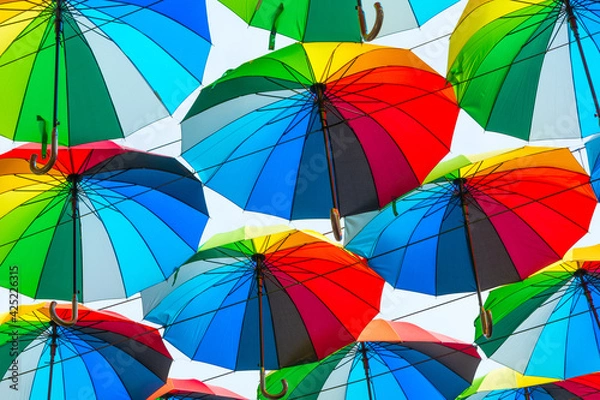 Obraz Bright colored umbrellas as a background
