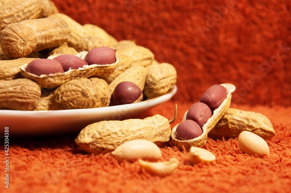 Fototapeta roasted peanuts in shell in a ceramic bowl