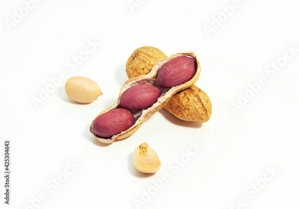 Obraz Roasted peanuts in shell on white background
