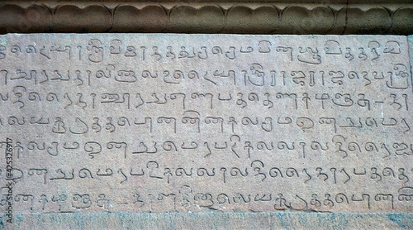 Fototapeta Inscriptions of Tamil language carved on the stone walls at Brihadeeswarar temple in Thanjavur, Tamilnadu, India. Ancient tamil inscriptions carved in the exterior temple walls in Thanjavur.