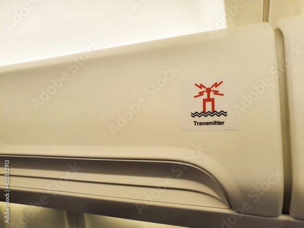 Obraz Sign of transmitter on aircraft overhead bin.