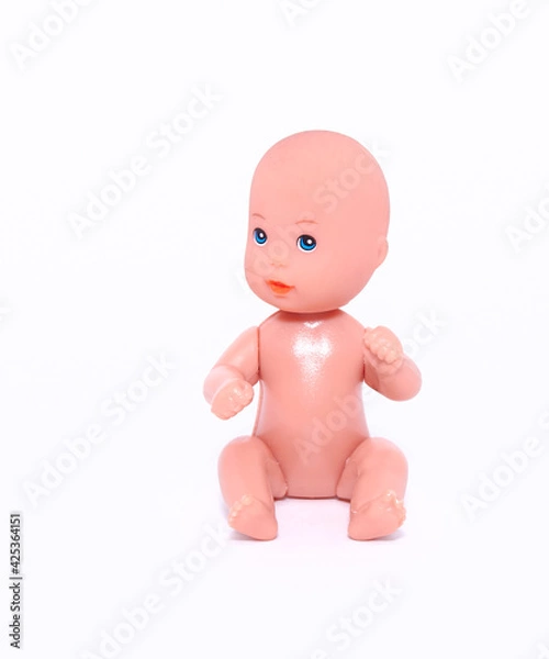 Obraz A small naked doll sits on an isolated white background. Close-up.