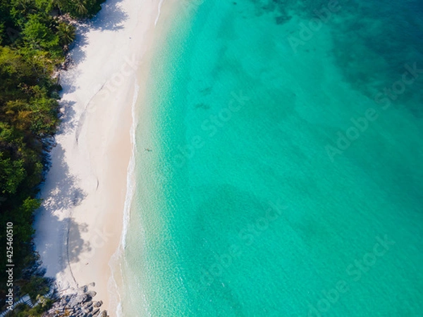 Fototapeta Aerial view nature summer sea waves in top-down drone shot perspective. Crashing wave line in Phuket South of Thailand. Andaman sea with foamy white beach.