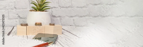 Fototapeta Stock market, coins, calculator, notepad, pen, and smartphone, and financial chart. Banner with a copy of the space and space for the text