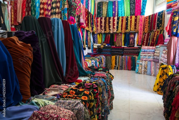Obraz Rolls of fabric and textiles in a factory shop. Multi different colors and patterns on the market Fabrics in rolls. Fabric store 