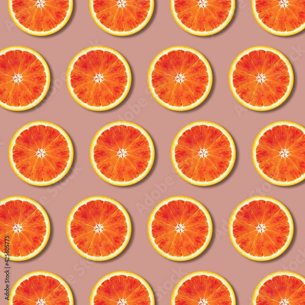 Fototapeta Geometric red orange fruit slices pattern, minimal flat lay food texture