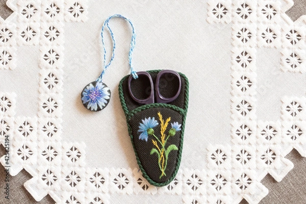 Obraz hand-embroidered scissors case on a napkin