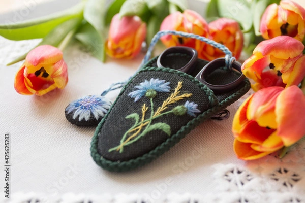 Obraz hand-embroidered case for scissors on a natural background
