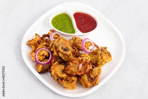 Fototapeta Indian Subcontinental Street Food With Various Names Like Onion Bhajji Pyaj Pakora Or Pakore Pyaaj Ke Pakode Or Pakoda Kanda Bhaji Pyaaz Bajji Served With Chutney And Ketchup Is Tea Time Chaat Snacks