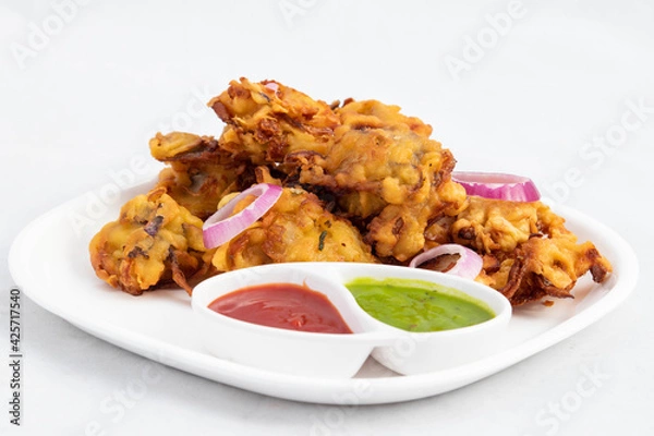 Fototapeta Most Enjoyed Indian Street Food With Various Names Like Onion Bhajji Pyaj Pakora Or Pakore Pyaaj Ke Pakode Or Pakoda Kanda Bhaji Pyaaz Bajji Served With Chutney And Sauce Is Tea Time Chaat Snacks