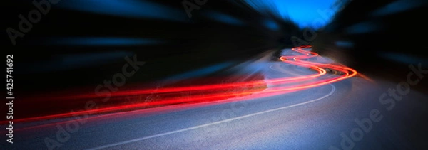 Fototapeta Panoramic - Cars light trails at night in a curve road