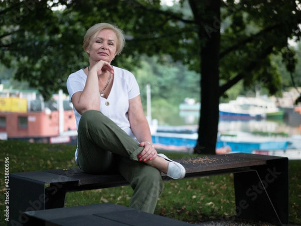 Obraz Old and stylish woman on a summer walk in beautiful city.