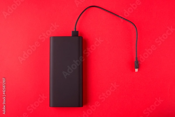 Fototapeta Black Power Bank with adapter for charging mobile devices. Power Bank close-up.