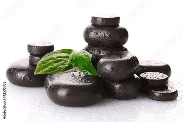 Fototapeta Spa stones with drops and green leaves isolated on white