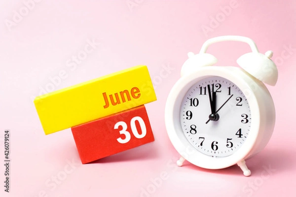 Fototapeta June 30th. Day 30 of month, Calendar date.White alarm clock on pastel pink background. Summer month, day of the year concept.