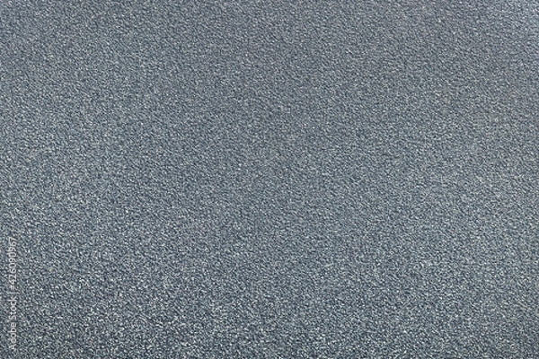 Fototapeta Gray shiny grainy background. Sparkling foil sequins. Abstract stock texture. Macro photo.