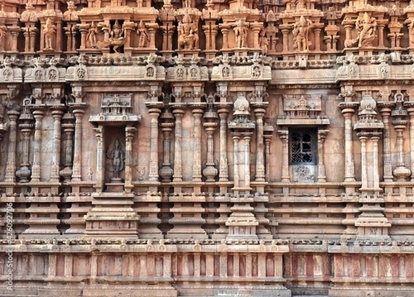 Fototapeta Detail of the facade of  the exterior wall of Brihadeeswarar temple in Thanjavur, Tamilnadu. Indian art of bas relief carving on the stone wall of ancient Hindu temple in Tamil nadu.