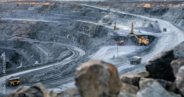 Fototapeta Work of heavy equipment in an open pit for gold ore mining