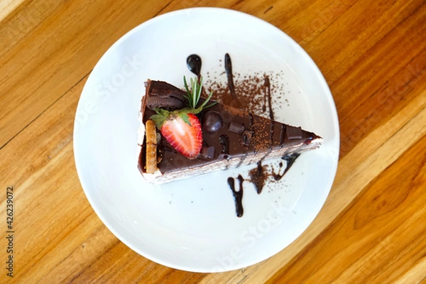 Obraz Homemade sweet sliced chocolate crepes cake with Strawberry and Cookies close-up on a plate. selective focus