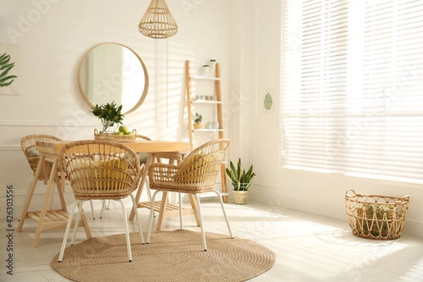 Fototapeta Stylish wooden dining table and chairs in room. Interior design