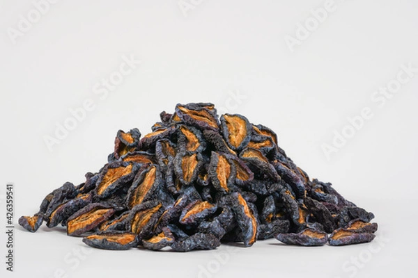 Obraz Natural dried prunes. Dried plums on white background. Studio photo. Free space for text. Product for sale.  Health, organic concept.