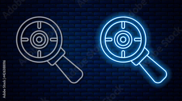 Fototapeta Glowing neon line Target financial goal concept with magnifying glass icon isolated on brick wall background. Symbolic goals achievement, success. Vector