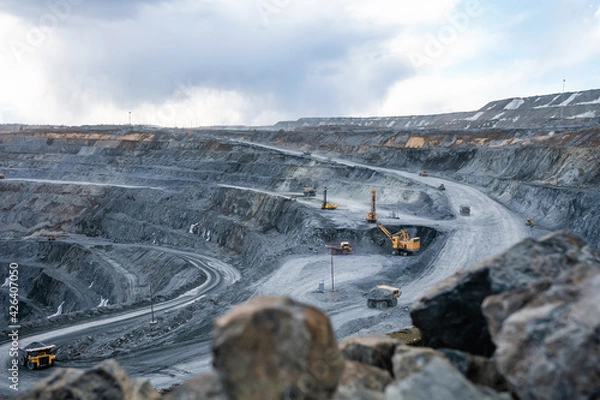 Fototapeta Work of heavy equipment in an open pit for gold ore mining