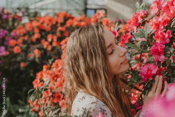 Obraz girl with red flowers in garden 