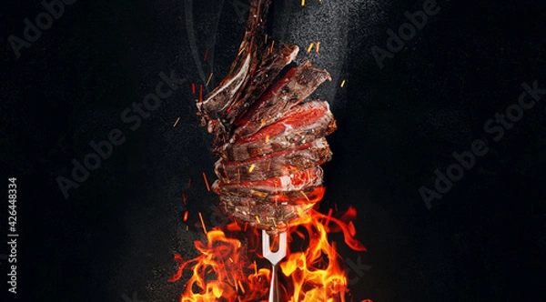 Fototapeta grilled beef steak on a dark background. expensive marbled beef of the highest grade fried to rare on the grill