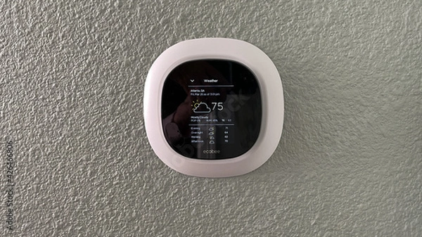 Obraz An Ecobee smart thermostat in a home.