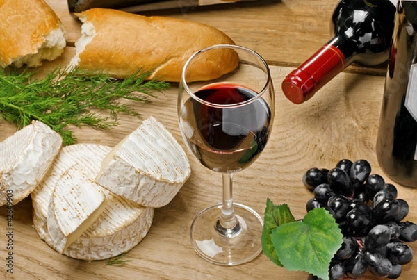 Obraz Red wine, Brie and Camembert cheeses with bread on the table