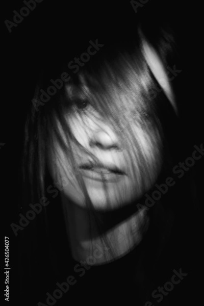 Obraz Blurred female portrait in the dark.