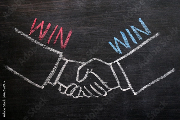 Obraz Mutual benefit concept of handshaking on blackboard