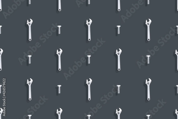 Fototapeta Adjustable metal wrench seamless pattern. Background from a metal wrench and a bolt. 