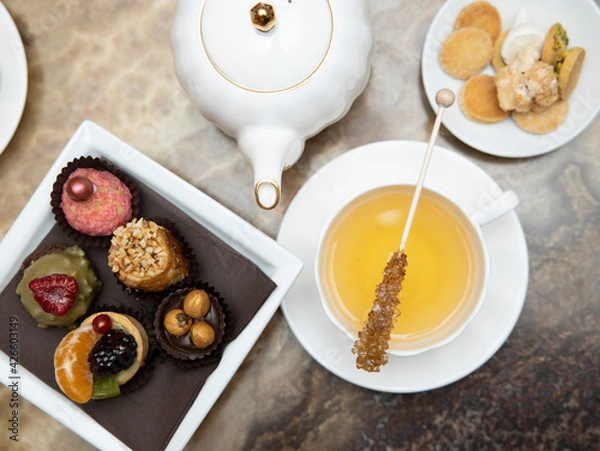 Obraz selective focus. Tea time with cake and cookies and cane sugar . Breakfast time. 