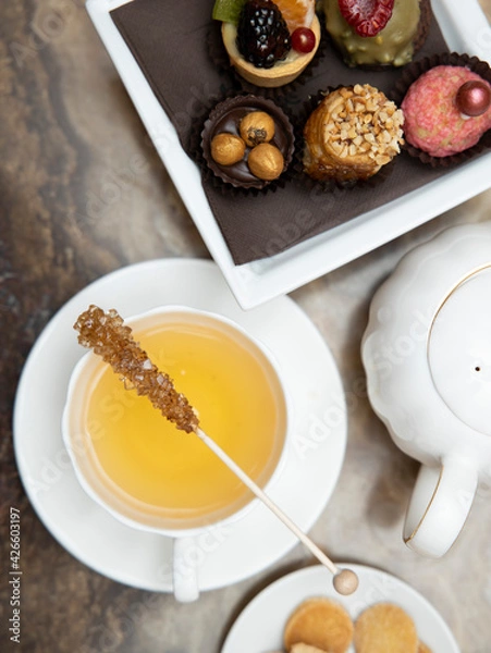 Obraz selective focus. Tea time with cake and cookies and cane sugar . Breakfast time. 