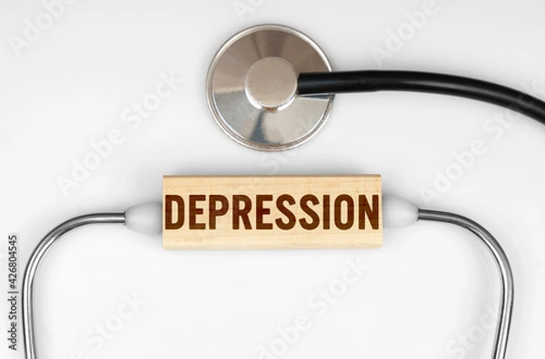 Fototapeta On the table is a stethoscope and a wooden plate with the inscription - DEPRESSION