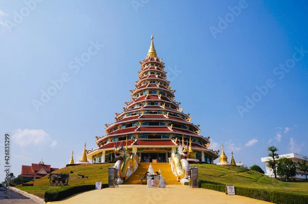 Obraz Wat Huay Pla Kang Temple, Beautifully with high stupa and elegance blue sky in the background. Located in Chiang Rai, Thailand.