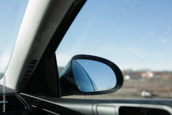 Fototapeta Rearview mirror, view from the car. Car door mirror.