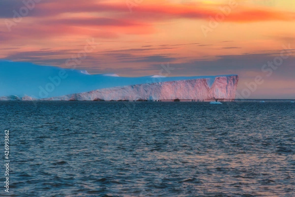 Fototapeta Sunset over an iceberg in the Icefjord, Greenland. Ilulissat Icefjord is a fjord in western Greenland and was declared a UNESCO World Heritage Site in 2004