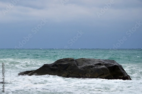 Obraz large stone in the sea. Mainly cloudy