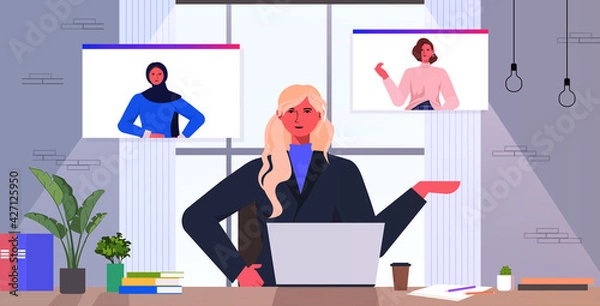 Obraz businesswoman having group video call with female colleagues in web browser windows