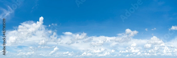 Fototapeta Panorama image Bright sky with fluffy clouds in white with an area of blue sky to add text for advertisement.