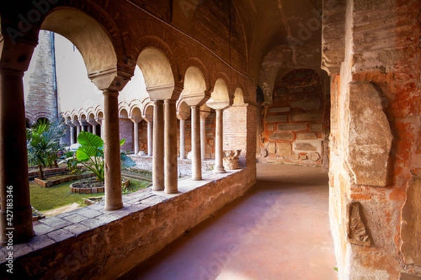 Fototapeta The Cloister of The Basilica of San Lorenzo fuori le Mura.A square corridor built in the 12th century,Numerous sarcophagi and bas-reliefs are arranged along the walls