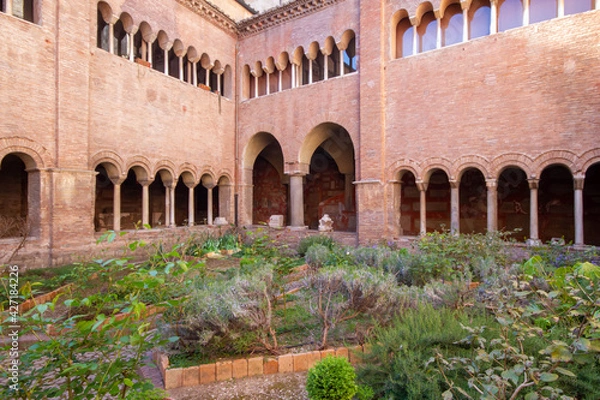 Fototapeta The Cloister of The Basilica of San Lorenzo fuori le Mura built in the 12th century, has three and four light windows, that can be seen on the upper floor overlook the garden