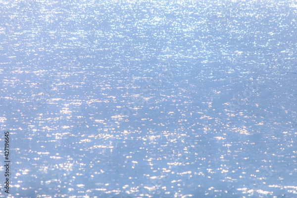 Obraz Soft sun light reflecting or sparkling glitter on water of sea or ocean with beautiful sky blue light tone.