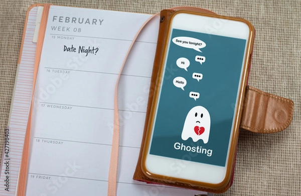 Obraz Ghosting on mobile phone on table with diary, Ghosted to cut all communication without explanation, ending a relationship. Social media dating.